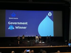 awards evening photo with people on stage and the government category on screen