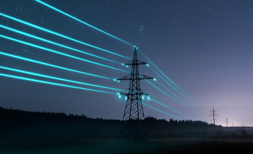 A photo of some electricity pylons at night