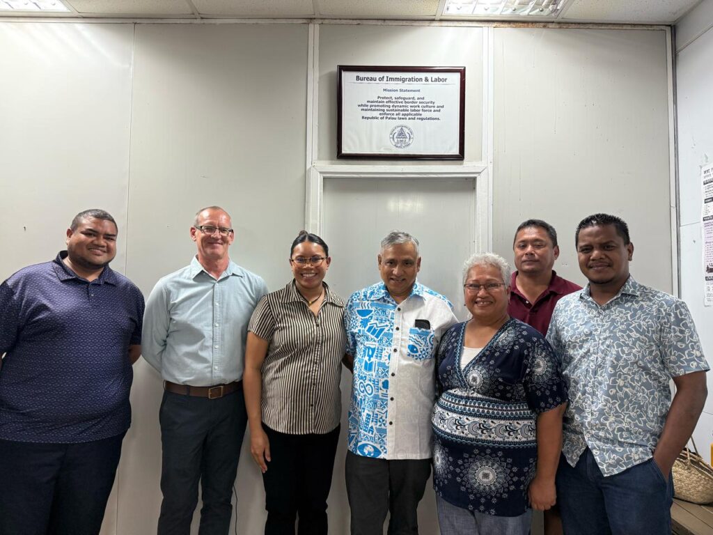 Ackama and agency staff in a building in Palau